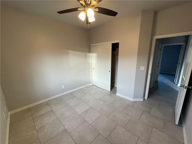 4933 N Famoso Dr, Kingman, AZ 86409 - unfurnished bedroom featuring a closet, baseboards, ceiling fan, and light tile patterned floors