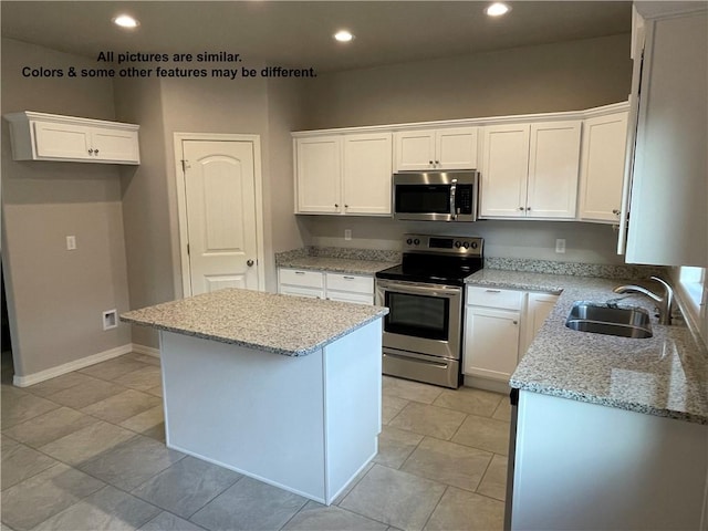 4933 N Famoso Dr, Kingman, AZ 86409 - kitchen featuring appliances with stainless steel finishes, a sink, a kitchen island, white cabinetry, and recessed lighting
