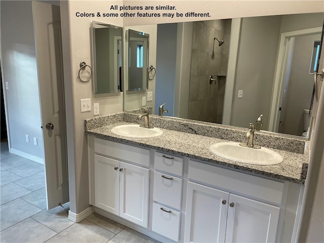 4933 N Famoso Dr, Kingman, AZ 86409 - full bathroom with baseboards, double vanity, tile patterned flooring, and tiled shower