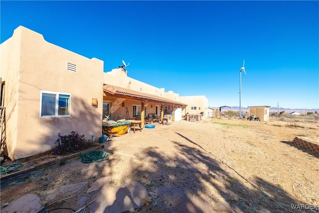 back of house featuring stucco siding