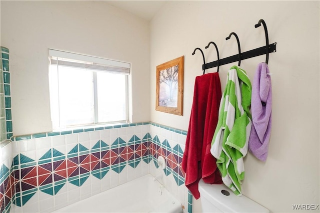 full bath featuring toilet and a bathing tub