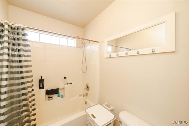 bathroom with shower / bath combo and toilet