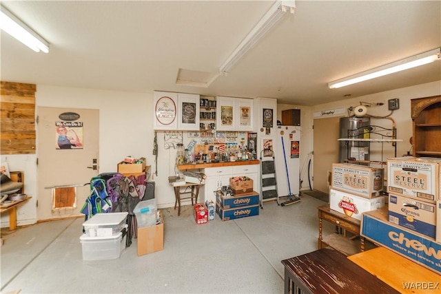 garage featuring visible vents and freestanding refrigerator