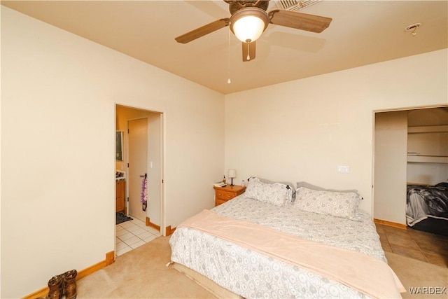 bedroom with ceiling fan, baseboards, vaulted ceiling, and light tile patterned flooring