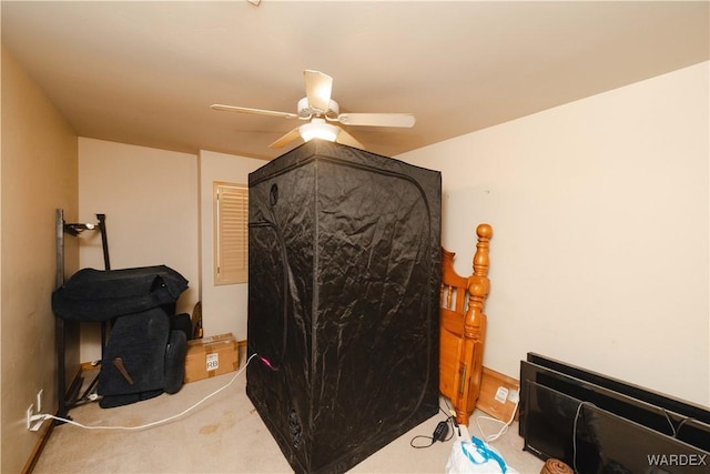 bedroom featuring light carpet and a ceiling fan