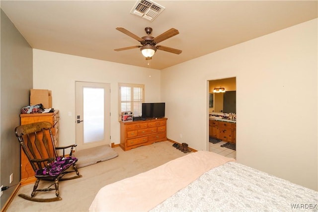 bedroom featuring light carpet, baseboards, visible vents, connected bathroom, and ceiling fan