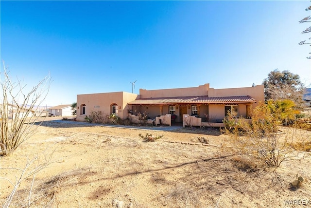 view of front of home with stucco siding and a tiled roof