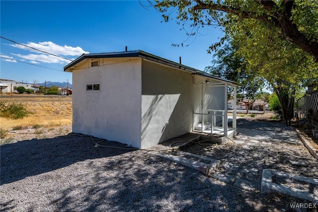 view of side of property featuring stucco siding