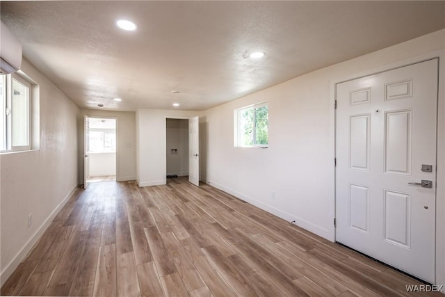 spare room with recessed lighting, light wood-style flooring, and baseboards