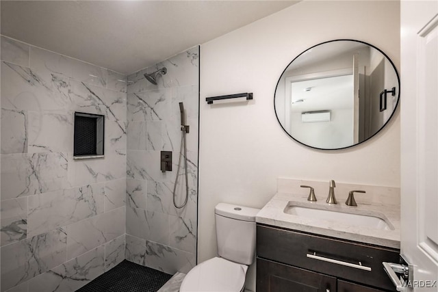 full bathroom featuring a stall shower, vanity, and toilet