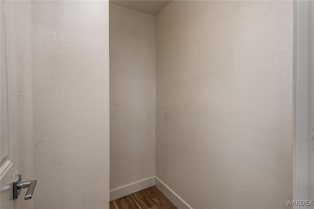 interior space with baseboards and wood finished floors