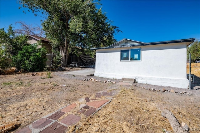 view of home's exterior with a patio area and stucco siding