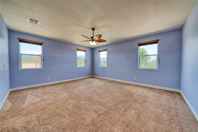 9076 E Mountain Shadow Rd, Kingman, AZ 86401 - carpeted spare room with a textured ceiling, a ceiling fan, and baseboards