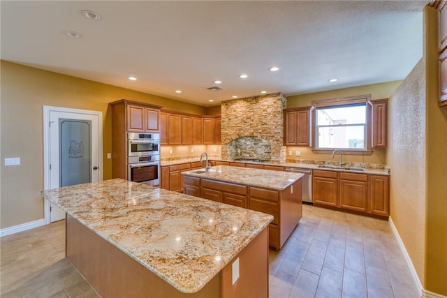 9076 E Mountain Shadow Rd, Kingman, AZ 86401 - kitchen with a center island with sink, appliances with stainless steel finishes, a sink, baseboards, and recessed lighting