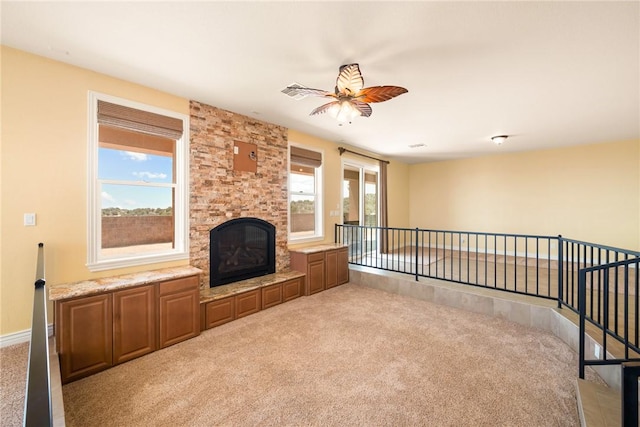 9076 E Mountain Shadow Rd, Kingman, AZ 86401 - unfurnished living room with carpet floors, a ceiling fan, and a tiled fireplace