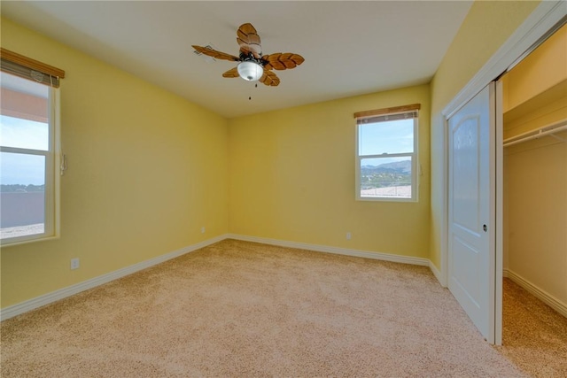9076 E Mountain Shadow Rd, Kingman, AZ 86401 - unfurnished bedroom featuring light carpet, baseboards, and a ceiling fan