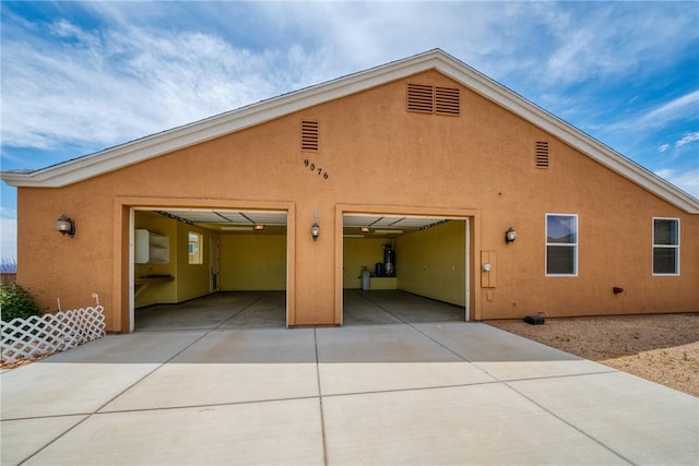 9076 E Mountain Shadow Rd, Kingman, AZ 86401 - back of house with stucco siding, driveway, and a garage