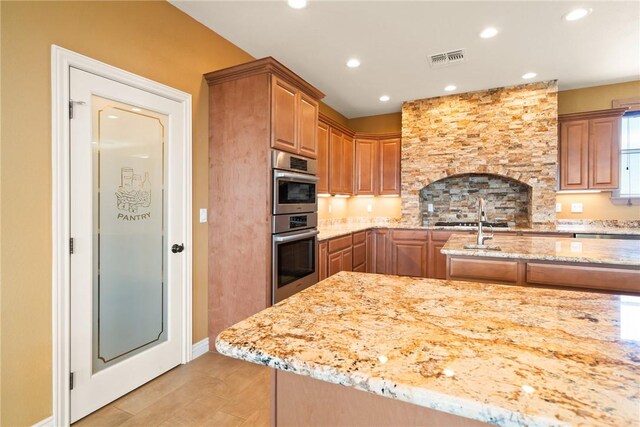 9076 E Mountain Shadow Rd, Kingman, AZ 86401 - kitchen featuring light stone counters, double oven, light wood-style flooring, recessed lighting, and baseboards