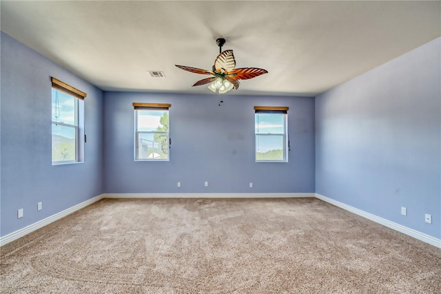 9076 E Mountain Shadow Rd, Kingman, AZ 86401 - spare room featuring carpet flooring, a ceiling fan, healthy amount of natural light, and baseboards