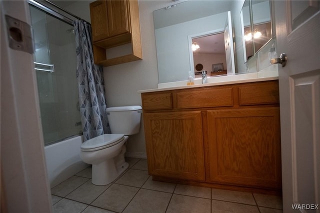 full bath featuring tile patterned flooring, shower / tub combo with curtain, vanity, and toilet