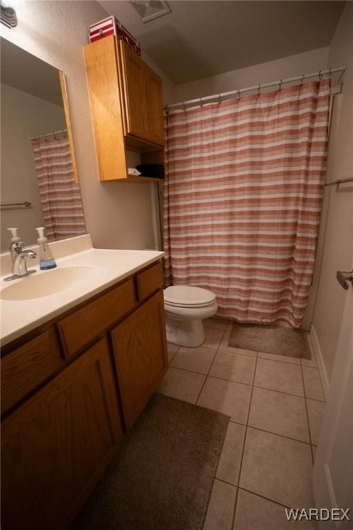 bathroom with visible vents, vanity, tile patterned flooring, and toilet