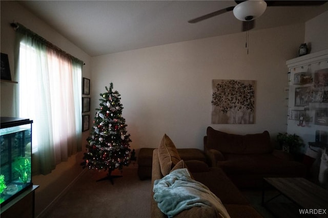 living room featuring a ceiling fan and carpet flooring