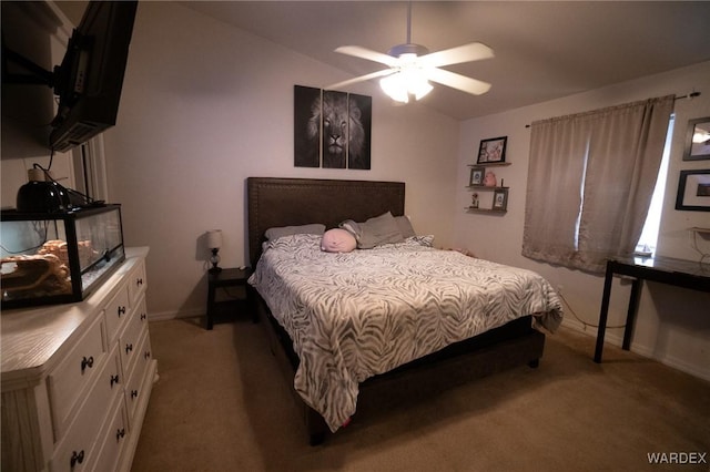 bedroom with light colored carpet, vaulted ceiling, baseboards, and ceiling fan