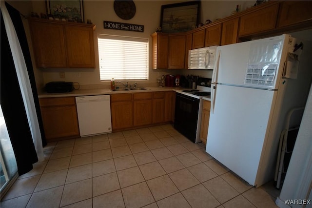 kitchen with light tile patterned floors, light countertops, brown cabinetry, a sink, and white appliances