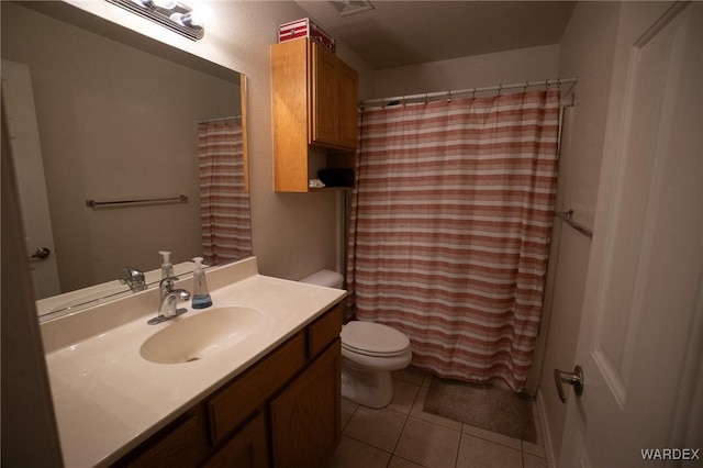 bathroom with tile patterned flooring, a shower with curtain, vanity, and toilet