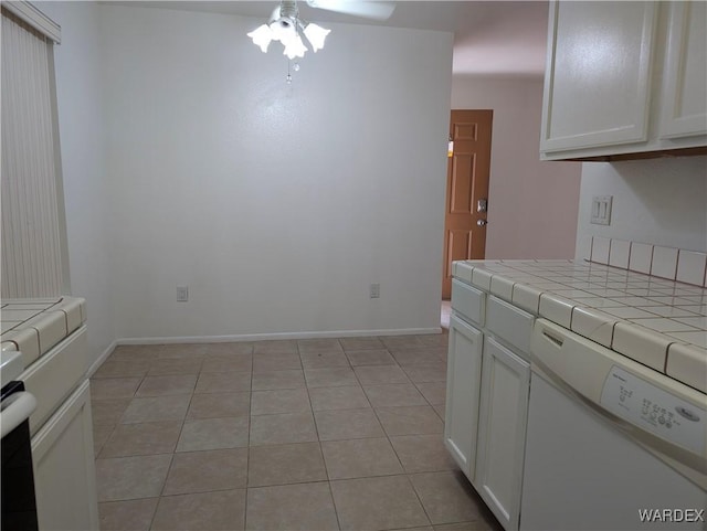 1280 Mohave Dr Unit 13, Bullhead City, AZ 86442 - kitchen featuring baseboards, tile counters, a ceiling fan, and white cabinets
