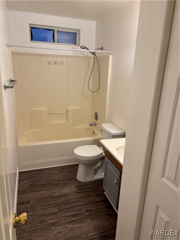 full bath featuring shower / bath combination, toilet, wood finished floors, and vanity