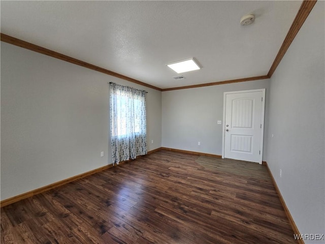 unfurnished room with crown molding, visible vents, baseboards, and dark wood-style flooring