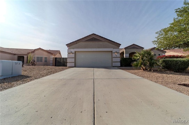 ranch-style home featuring an attached garage, concrete driveway, and stucco siding