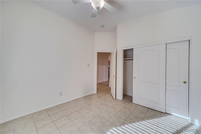 unfurnished bedroom with ceiling fan, baseboards, a closet, and light tile patterned flooring