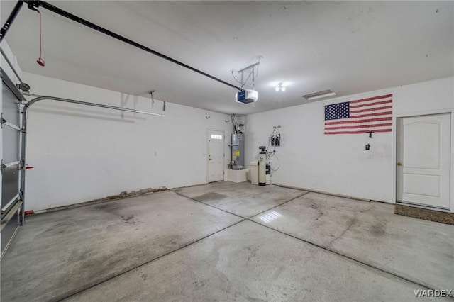 garage featuring gas water heater and a garage door opener