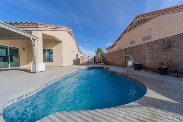 view of pool with a patio area and fence