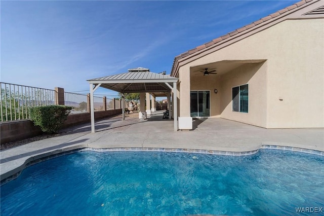 view of pool with a fenced in pool, a gazebo, a patio area, ceiling fan, and a fenced backyard