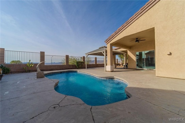 view of pool featuring ceiling fan, a fenced in pool, a fenced backyard, and a patio