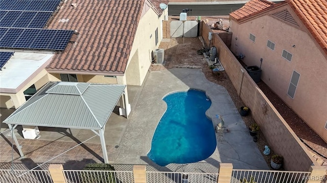 view of swimming pool with central air condition unit, fence, and a fenced in pool