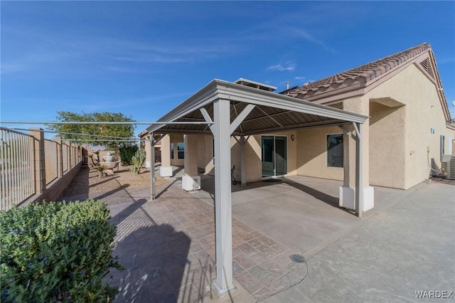 back of house featuring a patio area, a gazebo, fence, and stucco siding