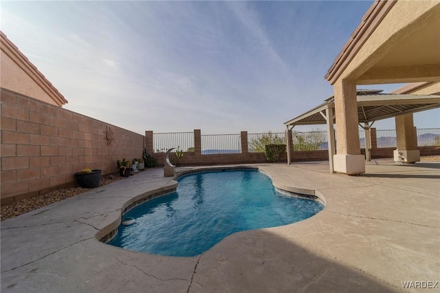 view of pool with a patio, a gazebo, a fenced backyard, and a fenced in pool