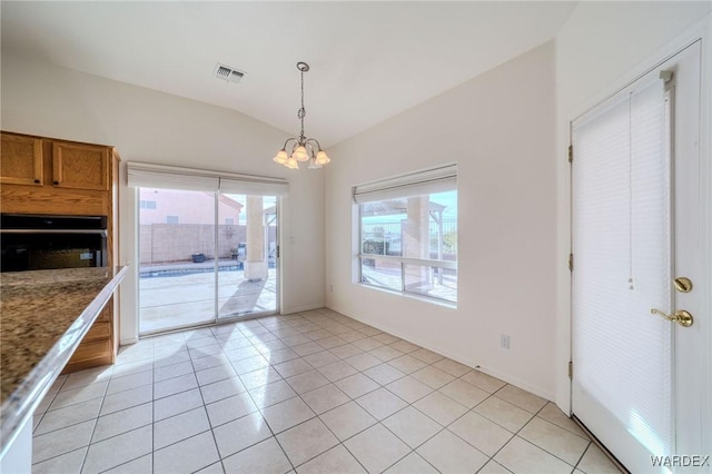 unfurnished dining area with light tile patterned floors, baseboards, visible vents, lofted ceiling, and an inviting chandelier