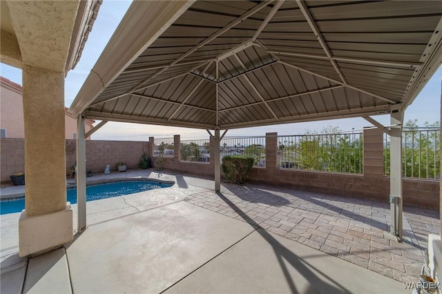 view of patio / terrace featuring a fenced backyard, a fenced in pool, and a gazebo