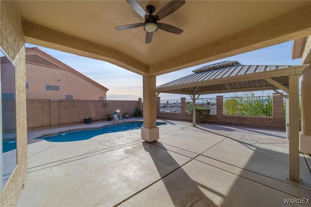 view of patio / terrace featuring a ceiling fan, a fenced in pool, and a fenced backyard