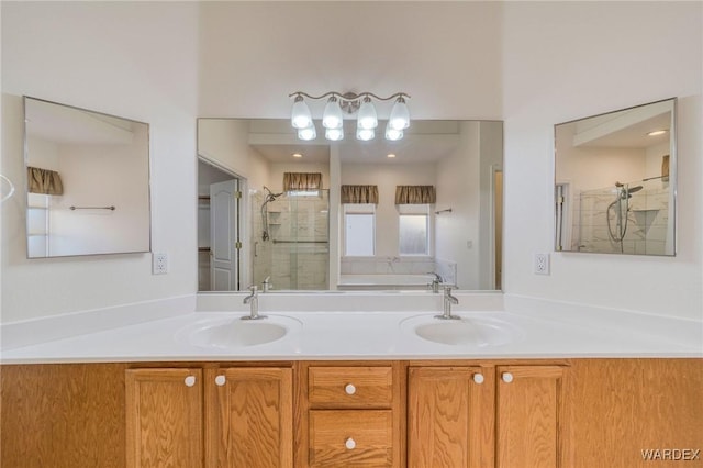 full bath with double vanity, a sink, and a shower stall