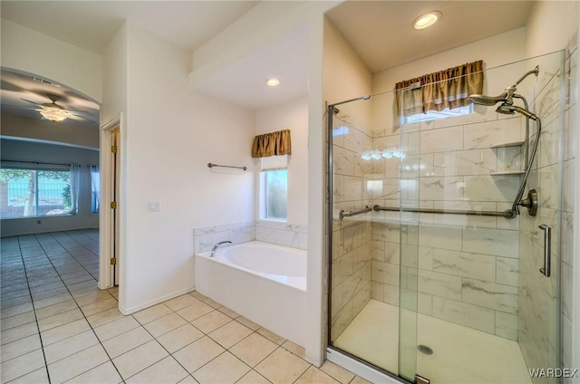 bathroom featuring tile patterned floors, ceiling fan, a shower stall, baseboards, and a bath