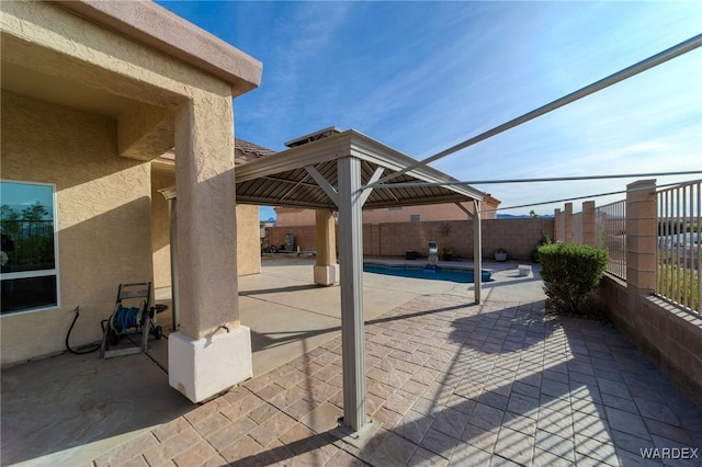 view of patio / terrace with a gazebo, a fenced backyard, and a fenced in pool