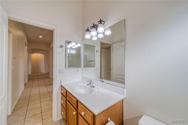 bathroom featuring toilet, tile patterned flooring, and vanity