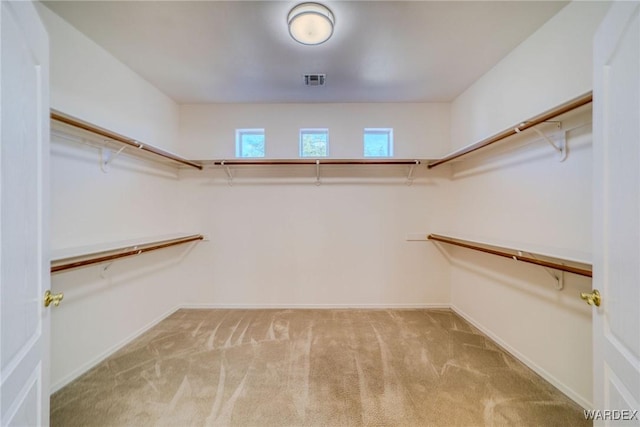 walk in closet with light carpet and visible vents