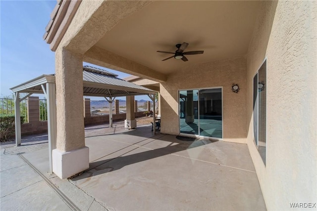 view of patio with a ceiling fan and a gazebo